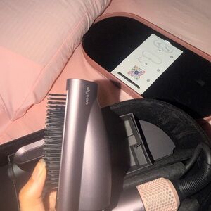 Dyson smoothing brush attachment for a Dyson hair styling device.